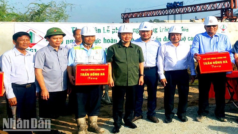 Deputy PM Tran Hong Ha presents gifts to workers working on the expressway.