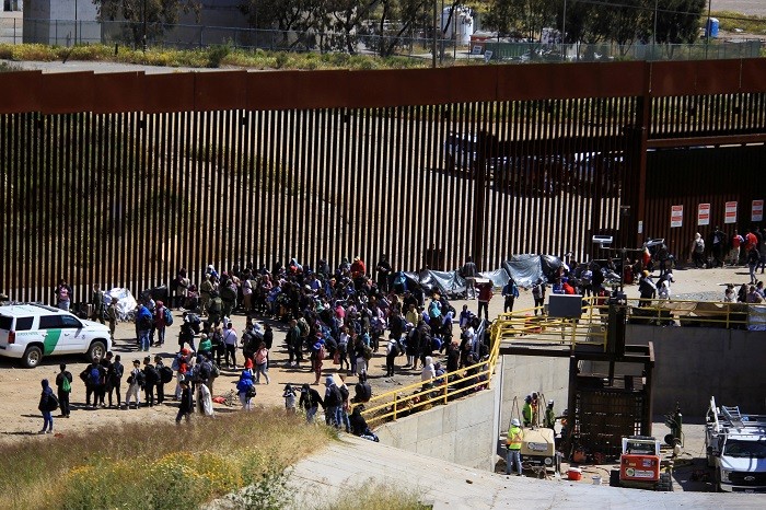 Migrants gather between the primary and secondary border fences in San Diego as the United States prepares to lift COVID-19 era restrictions known as Title 42, that have blocked migrants at the US- Mexico border from seeking asylum since 2020, as seen from Tijuana, Mexico May 8, 2023. (Photo: Reuters)