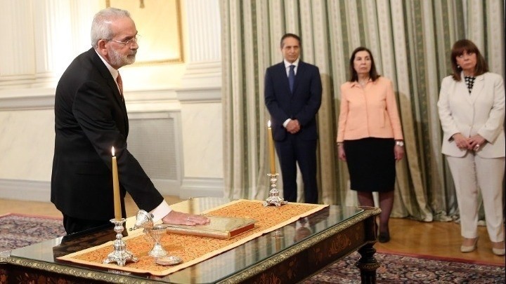 Court of Audit President Ioannis Sarmas was sworn in as prime minister of a caretaker government that will lead Greece to the second round of elections on June 25.