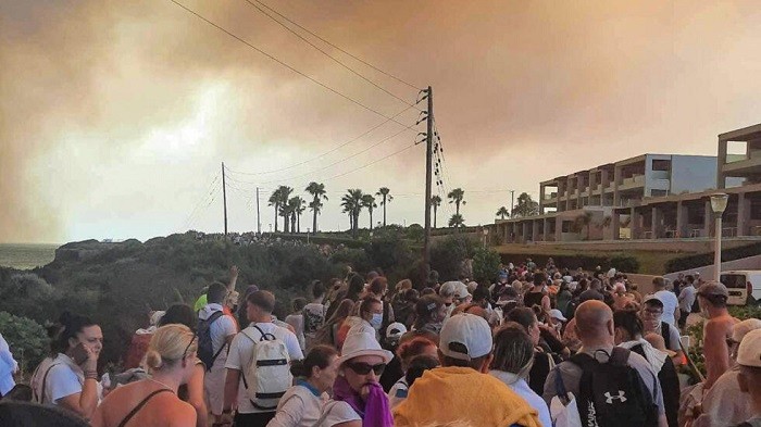 Officials on the Greek island of Rhodes evacuated thousands of locals and tourists from villages in the southeast of the Aegean island as wildfires rage.