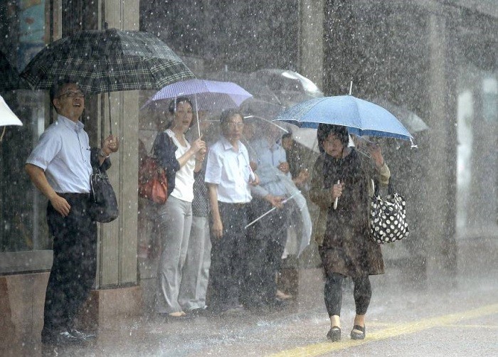 Typhoon Khanun pounded Japan's southwestern Okinawa and Kagoshima prefectures with heavy rain and gusty winds for a second straight day on Thursday, leaving two dead and moving so slowly its damaging impact could be prolonged.