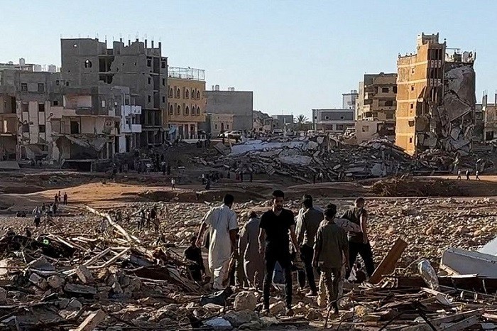 Survivors of a flood that swept away the centre of a Libyan city picked through the ruins on Thursday in search of loved ones from among thousands of dead and missing, while authorities feared an outbreak of disease from rotting bodies.