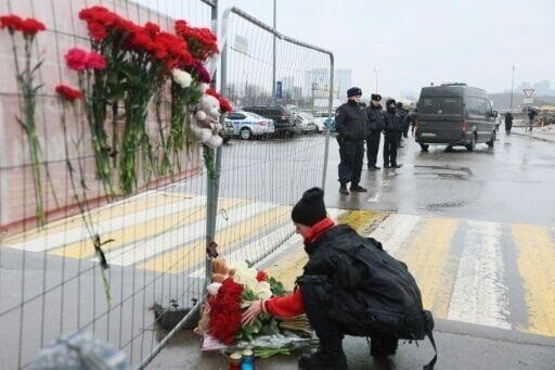 Flowers were laid outside a Moscow concert hall where at least 133 people were killed.