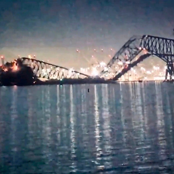 A major bridge collapsed in the U.S. port of Baltimore in the early hours of Tuesday after being struck by a container ship, plunging cars and as many as 20 people into the river below. Rescuers were searching for survivors in the Patapsco River after huge spans of the 1.6-mile (2.57 km) Francis Scott Key Bridge crumpled into the water.