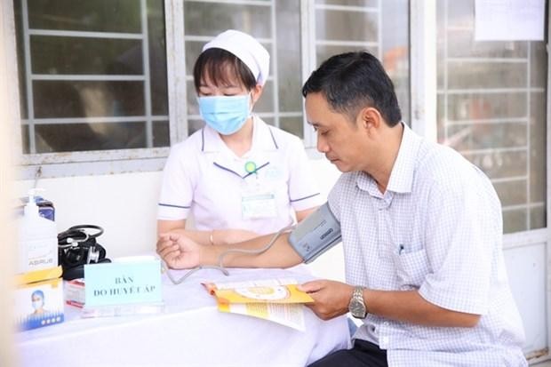 A man has his blood pressure checked by a medical worker under the Healthy Family programme in Vietnam. (Photo courtesy of Novartis Vietnam)