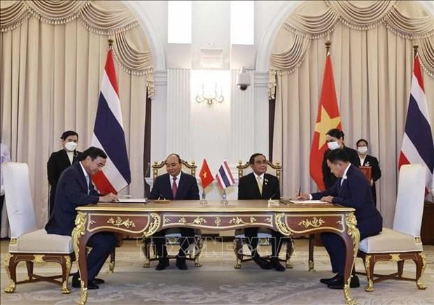 President Nguyen Xuan Phuc (sitting, left) and Prime Minister Prayut Chan-o-cha (sitting, right) witness the signing of the Memorandum of Understanding (MoU) on the Establishment of Sister City Relationship between and Thailand’s Khon Kaen province and Vietnam’s Da Nang city. (Photo: VNA)