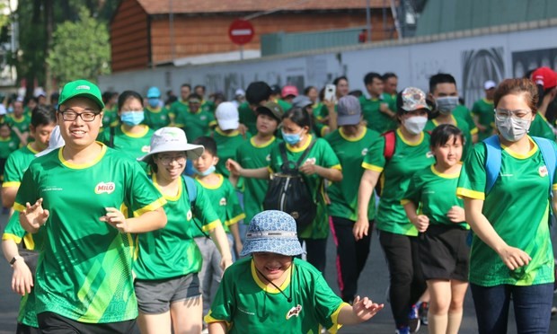 People join the Olympic Run Day in Ho Chi Minh City's District 1 on March 26. (Photo: VNA)