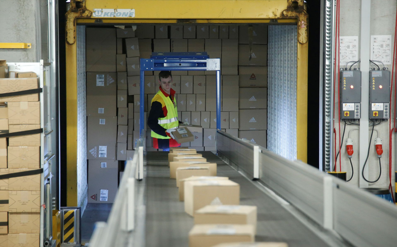 An employee puts parcels on a conveyor belt at a new DHL/Deutsche Post parcel centre in Bochum, Germany, November 18, 2019. (Photo: Reuters)