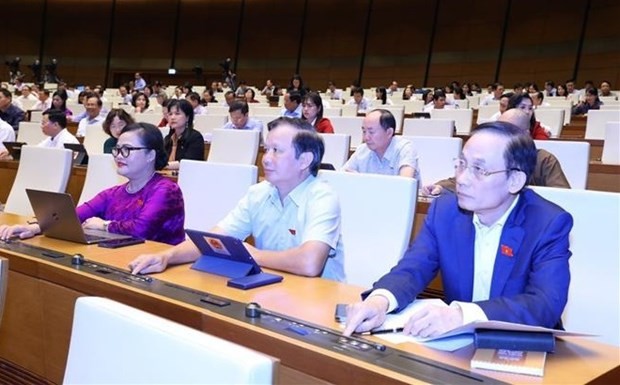 NA deputies press bottons to vote the resolution. (Photo: VNA)