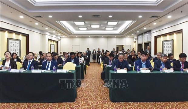 Vietnamese and Chinese participants in the conference in Beijing on November 27. (Photo: VNA)