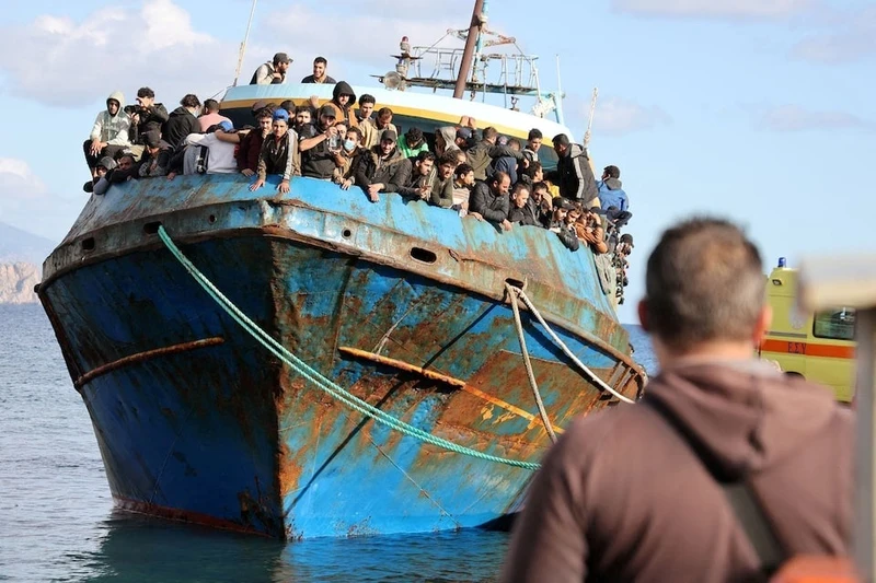 Migrants stand onboard a fishing boat at the port of Paleochora, following a rescue operation off the island of Crete, Greece, November 22, 2022. (Photo: Reuters)