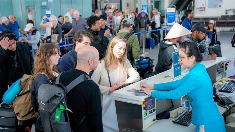 Passengers check in at Noi Bai International Airport.