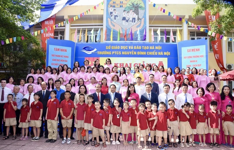 Prime Minister Pham Minh Chinh with teachers and students of Nguyen Dinh Chieu Secondary School. (Photo: NDO)