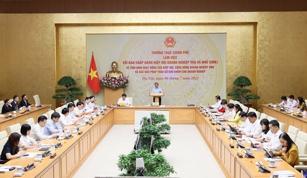 The meeting between permanent Government members and the executive committee of the Vietnam Association of Small and Medium Enterprises in Hanoi on July 6. (Photo: VNA)