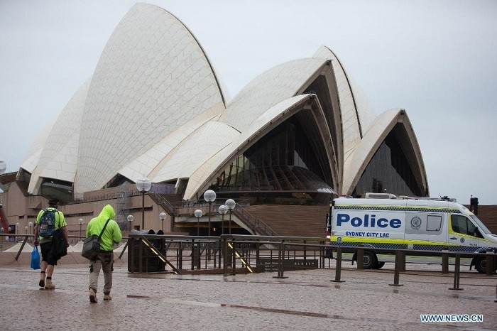 People walk in front of Sydney Opera House in Sydney, Australia, on July 14, 2021. Australia's state of New South Wales (NSW) on Wednesday announced to extend the lockdown on the Greater Sydney and surrounding areas for at least another two weeks until 11:59 p.m. July 30. (Photo: Xinhua)