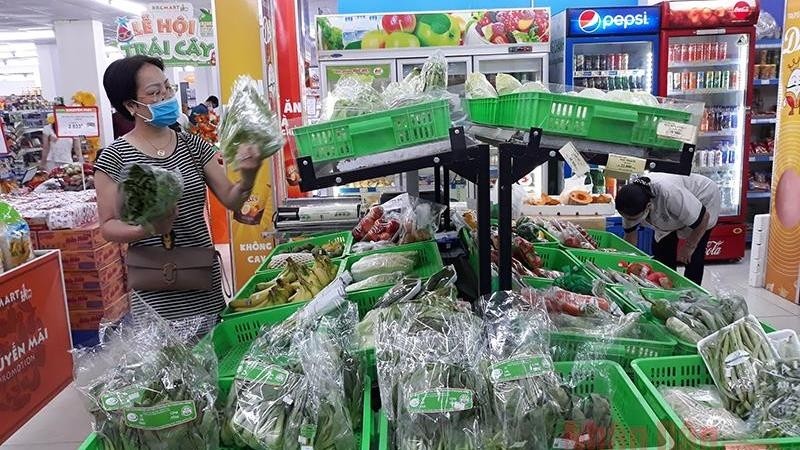 People go shopping at the Hapro Mart Thanh Cong supermarket on July 18.