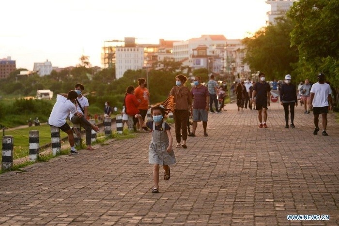 People walk on a street in Lao capital Vientiane July 21, 2021. Lao government on Monday decided to extend the ongoing lockdown for another 15 days to help curb COVID-19 infections. (Photo: Xinhua)