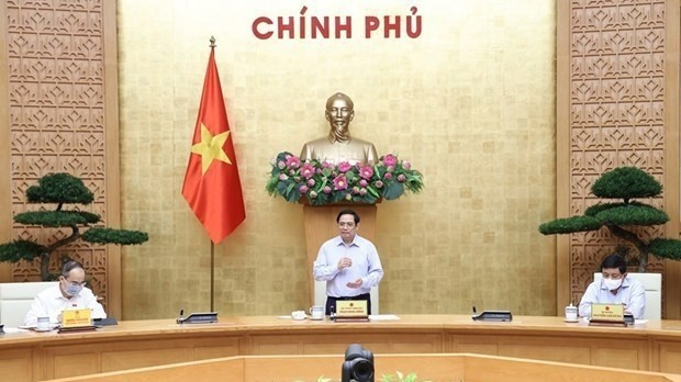 Prime Minister Pham Minh Chinh at a working session with leaders of ministries, vaccine producers and scientists in Hanoi on July 23 (Photo: VNA)