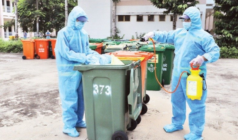 Workers from the Urban Environment Company disinfect medical waste related to the COVID-19 epidemic.