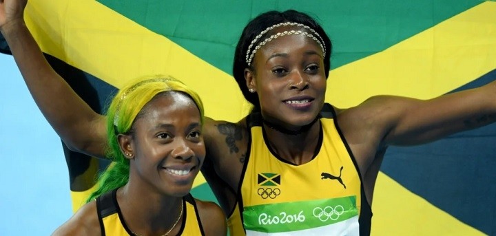 Elaine Thompson (R) of Jamaica celebrates winning the Women's 100m Final with Shelly-Ann Fraser-Pryce of Jamaica on Day 8 of the Rio 2016 Olympic Games at the Olympic Stadium on August 13, 2016 in Rio de Janeiro, Brazil. (Photo: Getty Images)