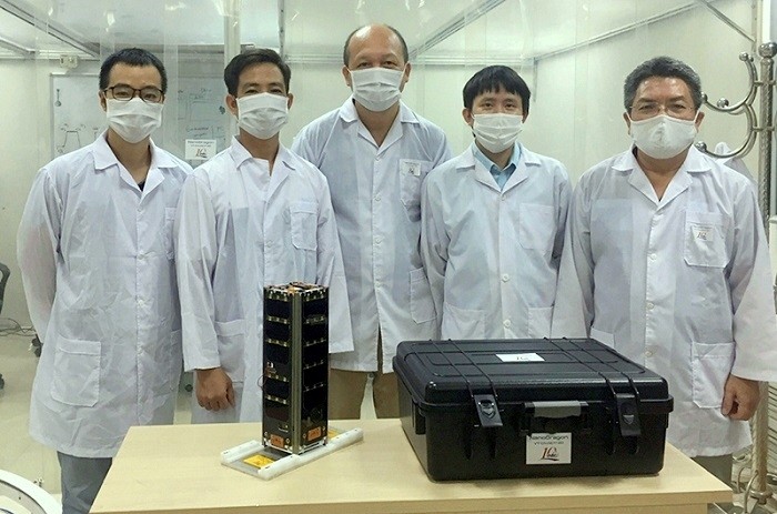 Scientists at the Vietnam National Space Centre pose with their NanoDragon satellite before sending it to Japan.