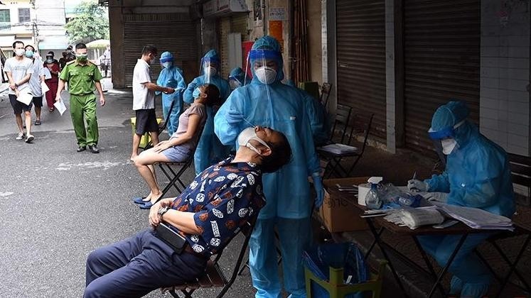Medical workers are collecting samples from residents in Hanoi's Dong Xuan Ward to be tested for coronavirus. (Photo: Duy Linh)