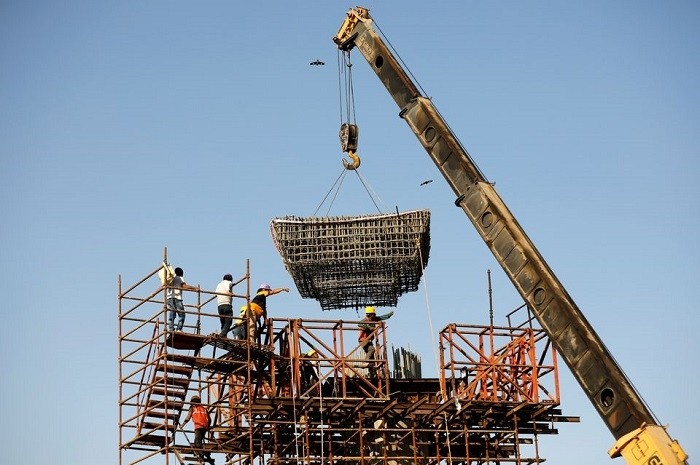 Workers build a pillar at the site of the metro railway flyover under construction in Ahmedabad, India, January 31, 2021. (File Photo: Reuters)