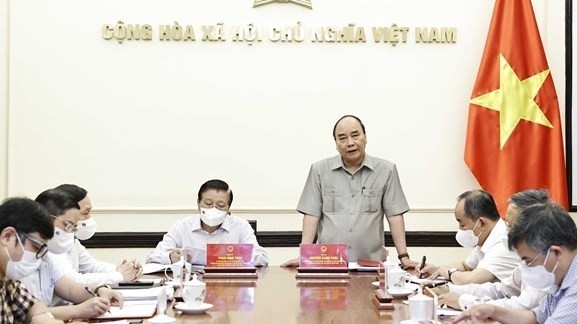 President Nguyen Xuan Phuc (standing), Head of the Central Steering Committee for Judicial Reform, speaks at the event. (Photo: VNA)