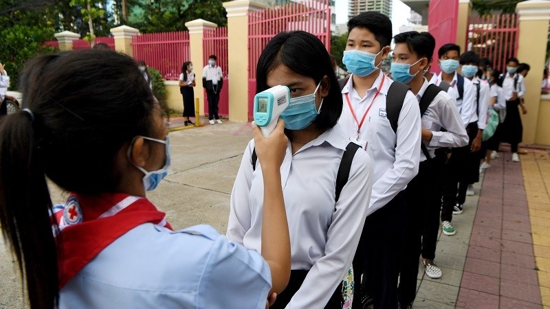 Students of a school in Phnom Penh have their body temperature checked. (Photo: AFP/VNA)