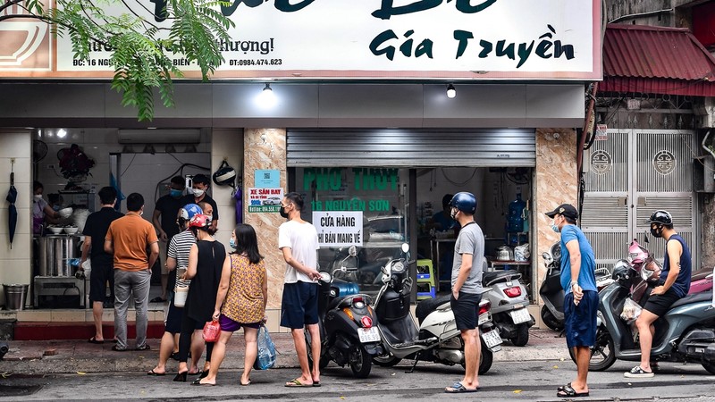 A noodle shop re-opens for business after more than one month of social distancing.