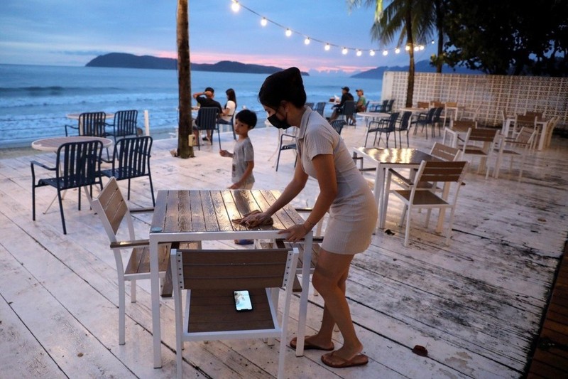 Esther Lee, owner of the Hidden Langkawi restaurant, cleans a table at her restaurant as Langkawi gets ready to open to domestic tourists from September 16. (Photo: Reuters)