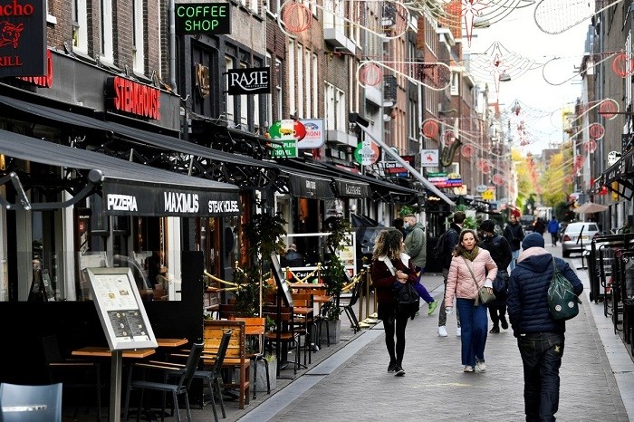 The Dutch government on Tuesday announced it is easing restrictions and will introduce a "corona" pass showing proof of vaccination to go to bars, restaurants, clubs or cultural events.