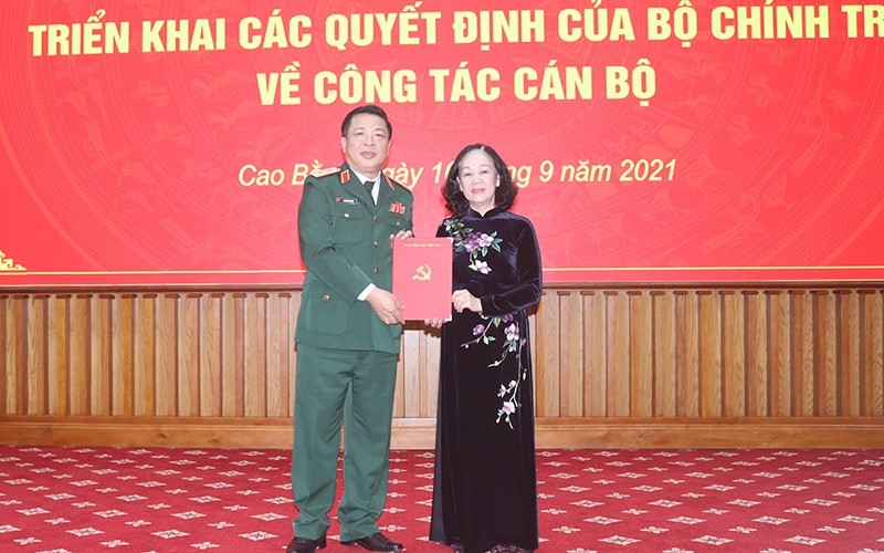 Politburo member and Head of the PCC's Organisation Commission Truong Thi Mai (R) hands over the Politburo's decision to Tran Hong Minh.