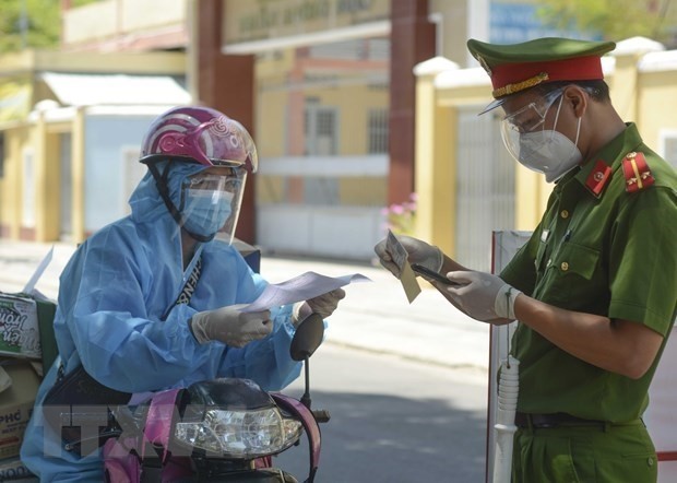 A policeman checks papers of a shipper in HCM City (Photo: VNA)