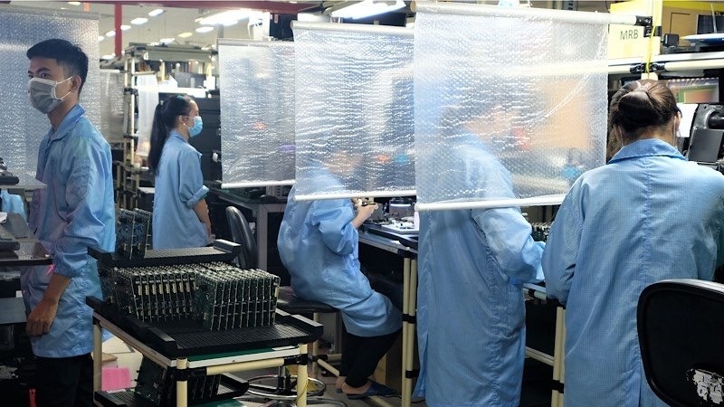 Employees are working at Datalogic Vietnam company which is implementing “three on the spot” production model in the Ho Chi Minh City High-Tech Park.