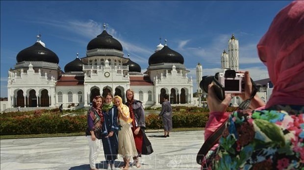 Foreign tourists visit Baiturrahman Mosque in Banda Aceh, Indonesia. (Photo: AFP/VNA)