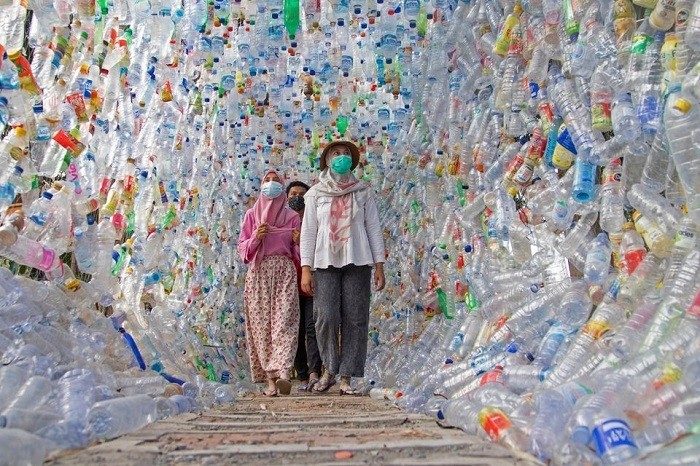 People walk through "Terowongan 4444" or 4444 tunnel, built from plastic bottles collected from several rivers around the city in three years, at the plastic museum constructed by Indonesia's environmental activist group Ecological Observation and Wetlands Conservation (ECOTON) in Gresik regency near Surabaya, East Java province, Indonesia, September 28, 2021. (Photo: Reuters)