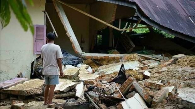 The photo shows a man looking at a collapsed house in Indonesia's Pariaman, after torrential rain triggered floods and landslides in the area. (Photo: AFP)
