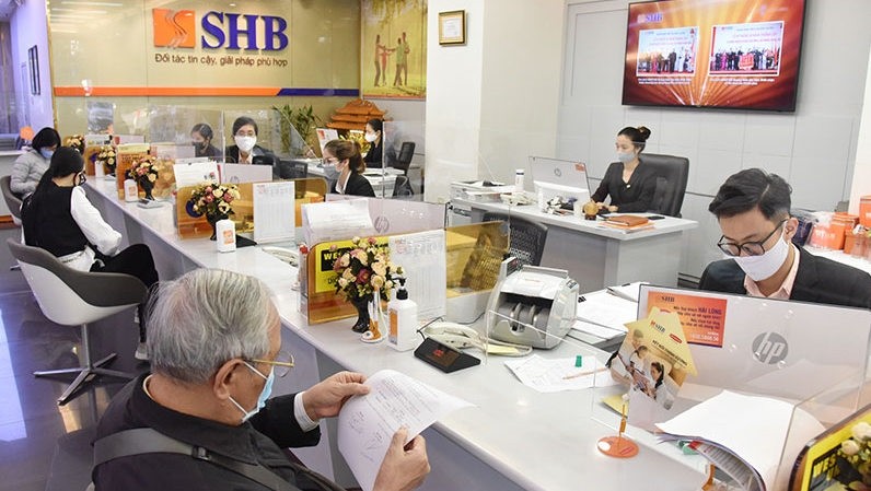 Customers are conducting banking transactions at SHB.