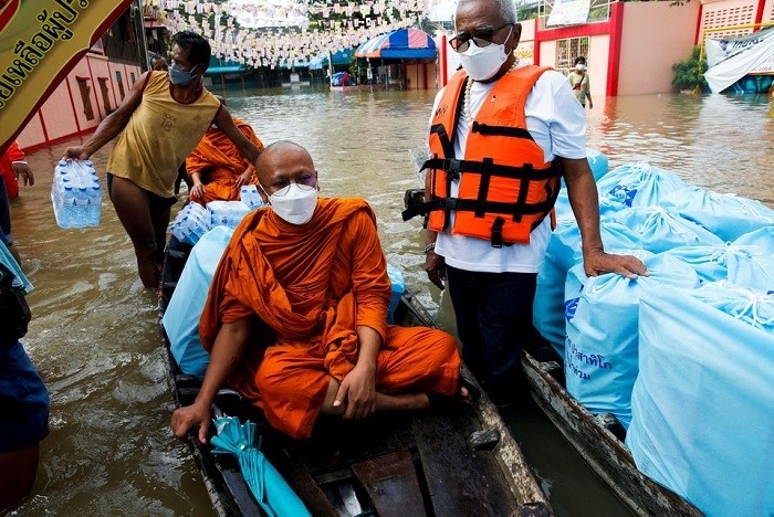 Buddhist monks deliver aid on a boat at a flooded area, at a temple in Ayutthaya, Thailand, October 6, 2021. (Photo: Reuters)