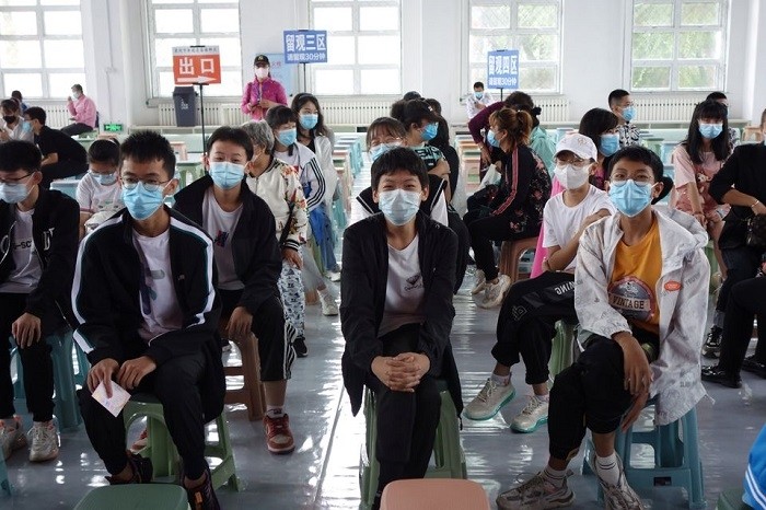 Residents wait at the observation area during a coronavirus disease (COVID-19) vaccination session for those aged between 12 and 14, in Heihe, Heilongjiang province, China August 3, 2021. (Photo: China Daily via Reuters)