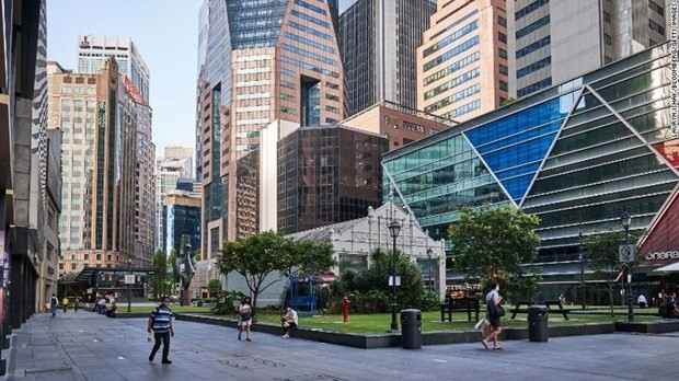 Pedestrians pass through a near empty Raffles Place in the central business district of Singapore (Photo: CNN)