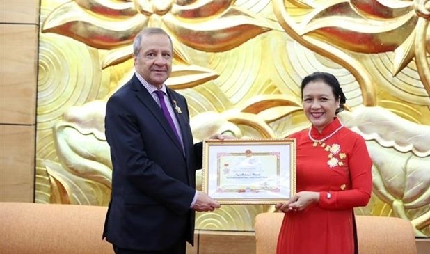 Algerian Ambassador to Vietnam Mohamed Berrah (L) receives the “For peace and friendship among nations” insignia. (Photo: VNA)