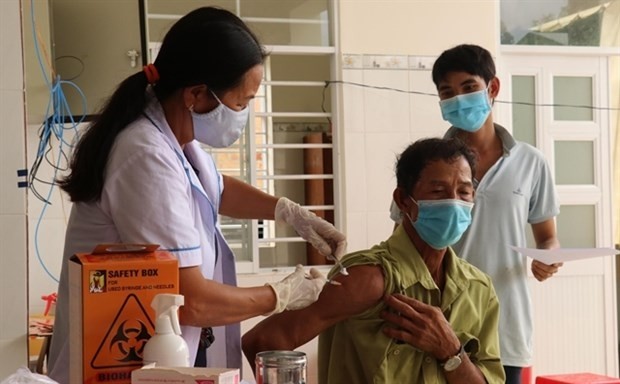 Citizens get vaccinated in a clinic in the southern province of Binh Phuoc. Economic growth after the COVID-19 pandemic will largely depend on the vaccine rollout. (Photo: VNA)