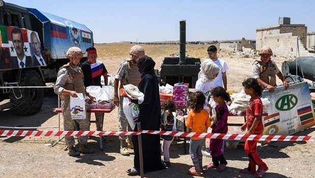 Distributing aid to people in Abu Duhur, Syria's Idlib. (Photo: AFP/VNA)