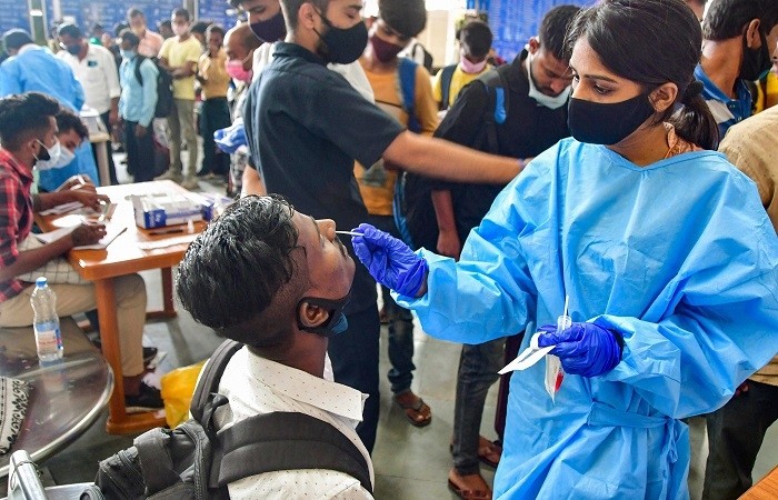 India's health ministry said on Tuesday states should ramp up COVID-19 testing as the world battles the new coronavirus variant Omicron, while some cities delayed the reopening of schools as a precautionary measure.