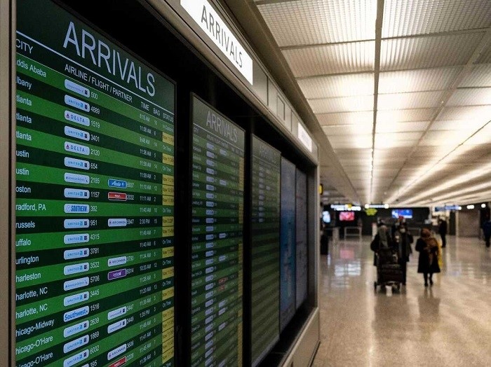 Travelers exit the International Arrivals area at Dulles International Airport in Dulles, Virginia, on November 29. The Biden administration is banning travel for non-US citizens from several African countries over concerns about the Omicron variant. (Photo: AFP via Getty Images)