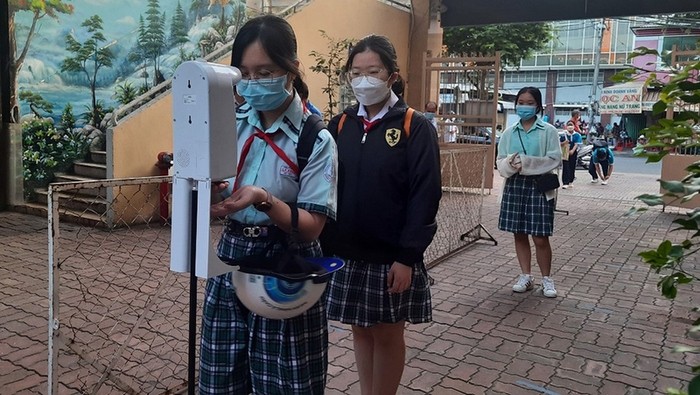 Students at Ly Phong Secondary School, District 5 receive body temperature measurement and disinfect their hands. (Photo: NDO)
