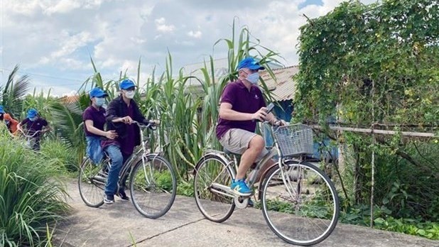 Tourists ride bicycles to tour Can Gio district of Ho Chi Minh City (Photo: VNA)