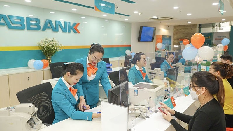 Customers are conducting banking transactions at AB Bank.